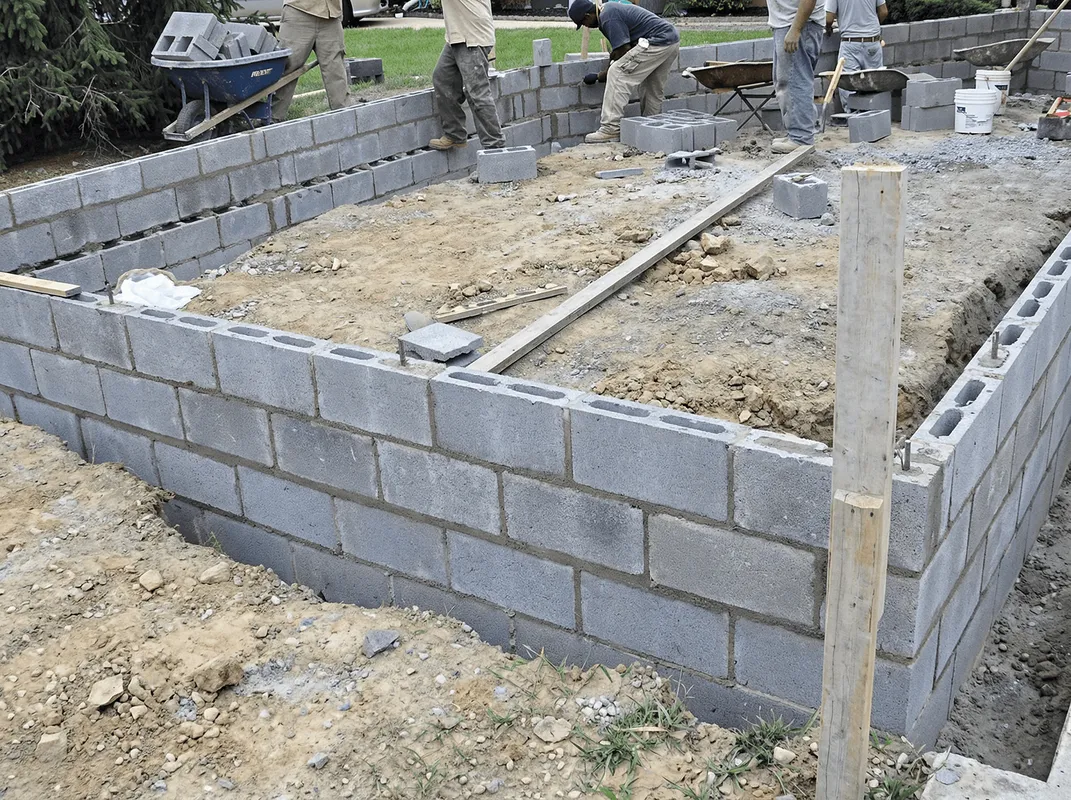 Professionals building a foundation with blocks in Albany, NY